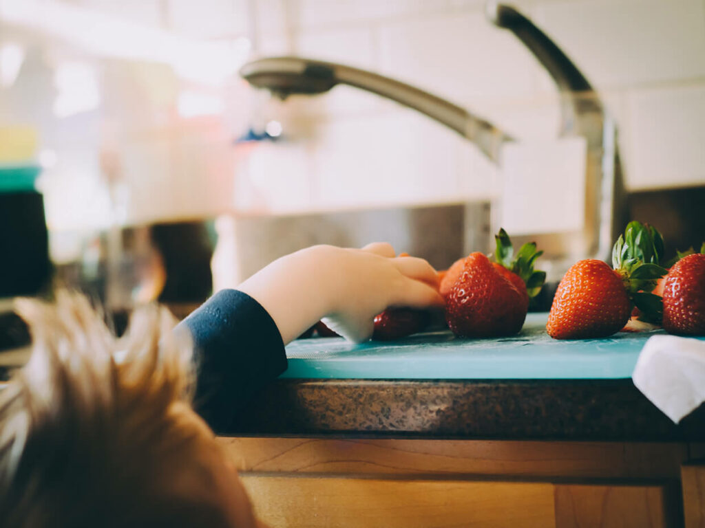 Child reaching for fruit