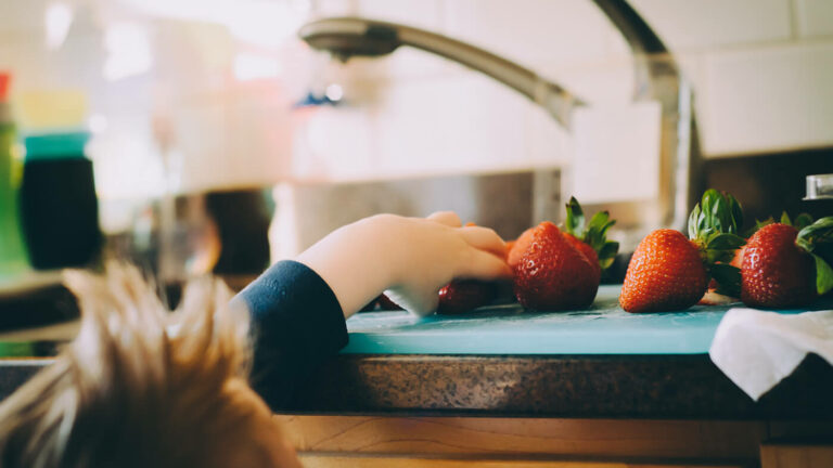 Child reaching for fruit